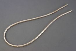 A white metal bead and bar collar necklace. Twist clasp.