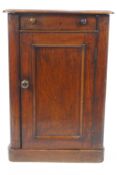 A Victorian mahogany wash stand with opening top above one panelled door on plinth base,