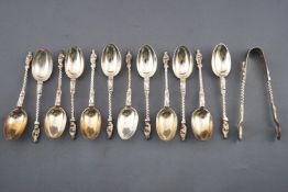 A set of twelve silver Apostle rat tail coffee spoons, and a pair of sugar tongs,