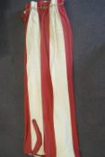 A pair of raspberry and cream vertically striped curtains,