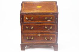 An Edwardian mahogany and satinwood cross-banded bureau with three graduated drawers,