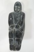 An 20th century Inuit soft stone carving of a figure, 20cm high,