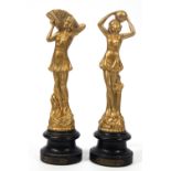 A pair of French Art Deco style figures of Ladies, later gold painted,