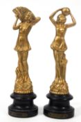 A pair of French Art Deco style figures of Ladies, later gold painted,