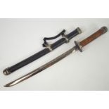 A replica Japanese short sword or Wakizashi with a carved wood metal capped handle with Tsuba