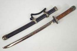 A replica Japanese short sword or Wakizashi with a carved wood metal capped handle with Tsuba