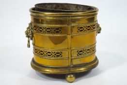 A 19th century oval brass coal bucket with pierced bands on ball feet,