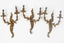 A group of three gilt brass two branch Rococo C and S scroll wall bracket lights