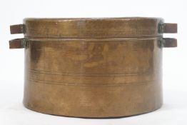 A large copper two handled pan and cover,