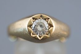 A yellow metal single stone ring. Set with a round cut cubic zirconia.