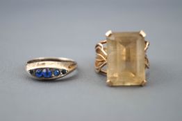 A yellow metal large dress ring set with a rectangular cut yellow quartz. Stamped 9ct, size N.