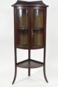 A Edwardian mahogany standing corner cabinet with chequer stringing,