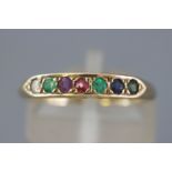 A yellow metal half hoop dress ring set with multi gemstones to spell 'Dearest'.