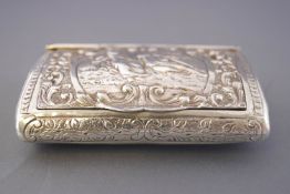 A Continental white metal snuff box of elongated oval section with lift up hinged cover,