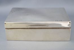 A silver cigarette box, of plain rectangular form with a slightly domed lid, Birmingham 1927,