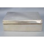 A silver cigarette box, of plain rectangular form with a slightly domed lid, Birmingham 1927,