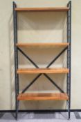 A Ladderax modular unit bookshelf with black uprights and four shelves,