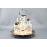 A cut glass four piece cruet set with silver plated mounts and stand. 22cm high.