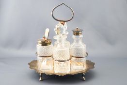 A cut glass four piece cruet set with silver plated mounts and stand. 22cm high.