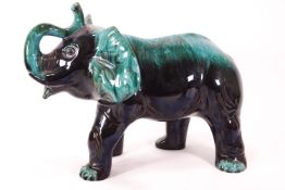 A large streaked turquoise glazed Poole pottery figure of a trumpeting elephant,