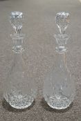 A pair of cut glass decanters and stoppers, engraved with grape vines,