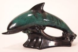 A large streaked Poole pottery turquoise figure of a leaping dolphin,