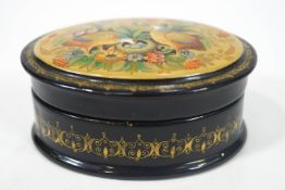 A signed Russian lacquer oval box with a hinged cover,