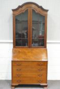 An Edwardian mahogany bureau bookcase in the Dutch style with two glazed doors