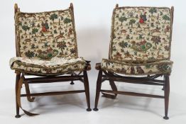 A pair of Parker Knoll chairs with turned tapering frame and original fabric covered cushions,