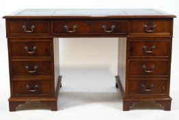 A 20th century mahogany pedestal desk with leather inset top and three frieze drawers