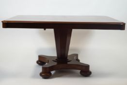 A William IV mahogany breakfast table, on waisted rectangular base and bun feet enclosing casters,