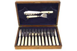 An oak cased set of twelve fish knives and forks with fish servers