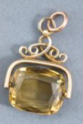 A yellow metal fob seal pendant having a cushion faceted cut citrine quartz.