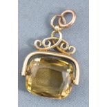 A yellow metal fob seal pendant having a cushion faceted cut citrine quartz.