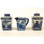 Two pottery tea caddies and covers, together with a water jug,