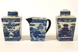 Two pottery tea caddies and covers, together with a water jug,