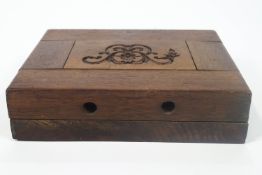 A carved limewood mould for a Gesso motif, set in a mahogany block,
