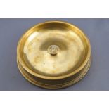 A 1918 brass shell end, 4" 80 calibre, converted to an ashtray, and set a Naval button,