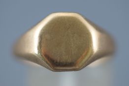 A yellow metal signet ring. Plain polished finish. Hallmarked 9ct gold.