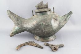 An Asian cast metal ewer in the form of a stylized fish with lift off cover with fish knop,