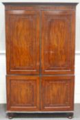 A 19th century linen press with two panelled doors enclosing four sliding shelves above two further