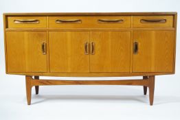 A G-Plan teak sideboard, with three frieze drawers above two cupboard doors,