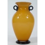 An Art glass two handled urn of traditional form with an amber flash over an opaque body