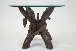 A Black Forest carved wood four part table stand, realistically carved as branches,