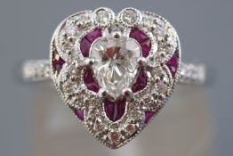 A white metal heart shape cluster ring having a central heart faceted cut diamond