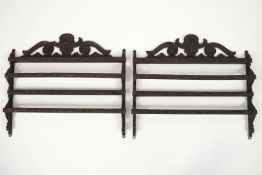 A pair of carved oak wall racks, decorated with flowers and scrolls,
