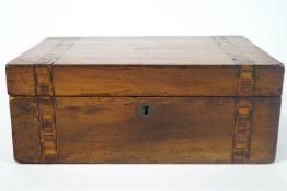 A 19th century walnut sewing box (lacking interior), the top with two parquetry bands,