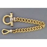 A yellow metal heavy curb link bracelet with feature swivel and toggle clasp