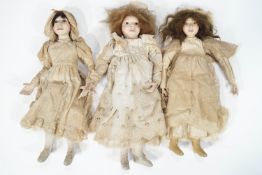 Three 20th century dolls with individual pottery heads and hands, and stuffed bodies,