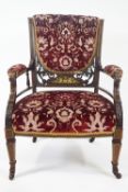 An Edwardian rosewood and ivory inlaid saloon chair on square tapering legs with ceramic casters